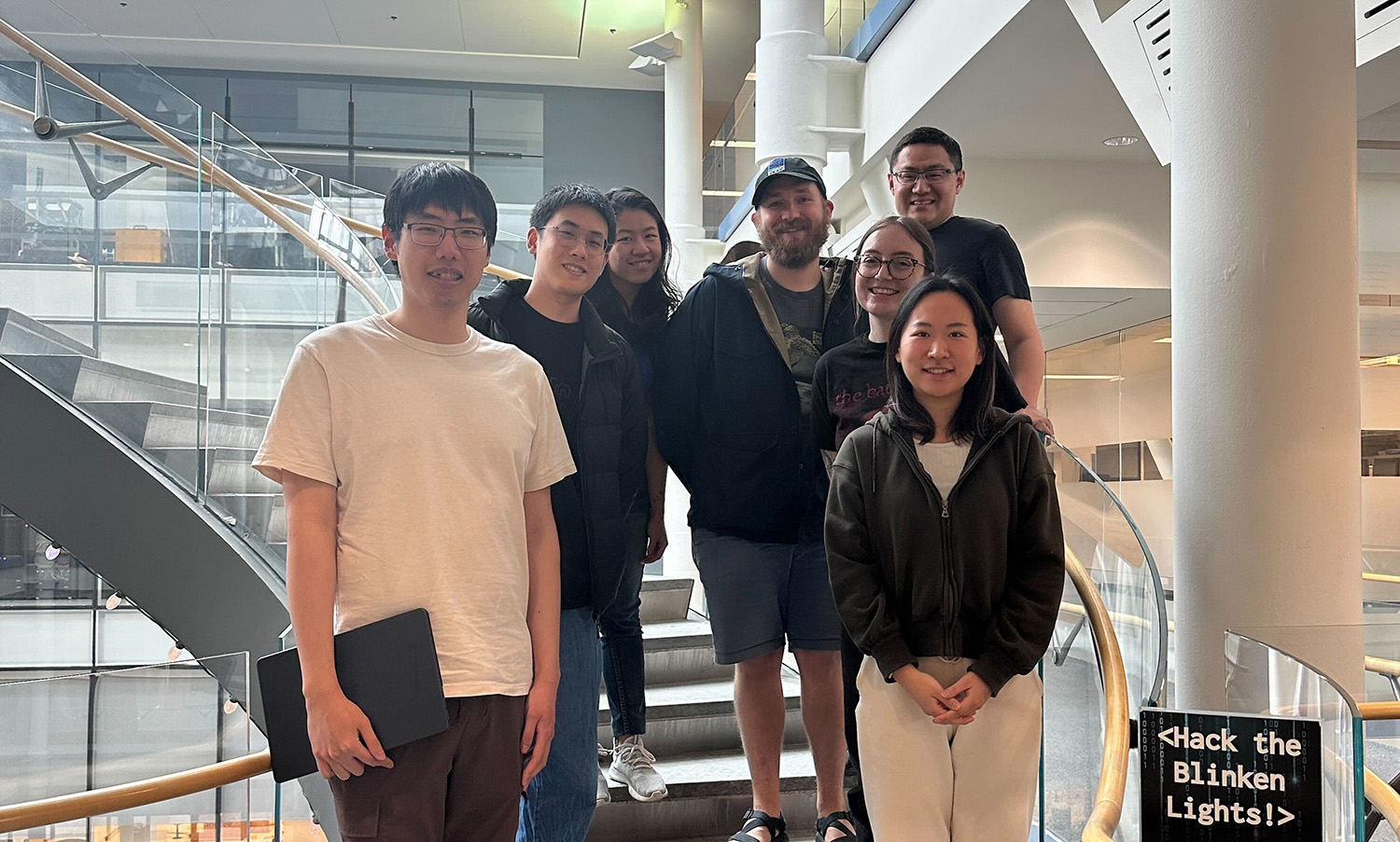 The Human-AI research group stanting together on a staircase